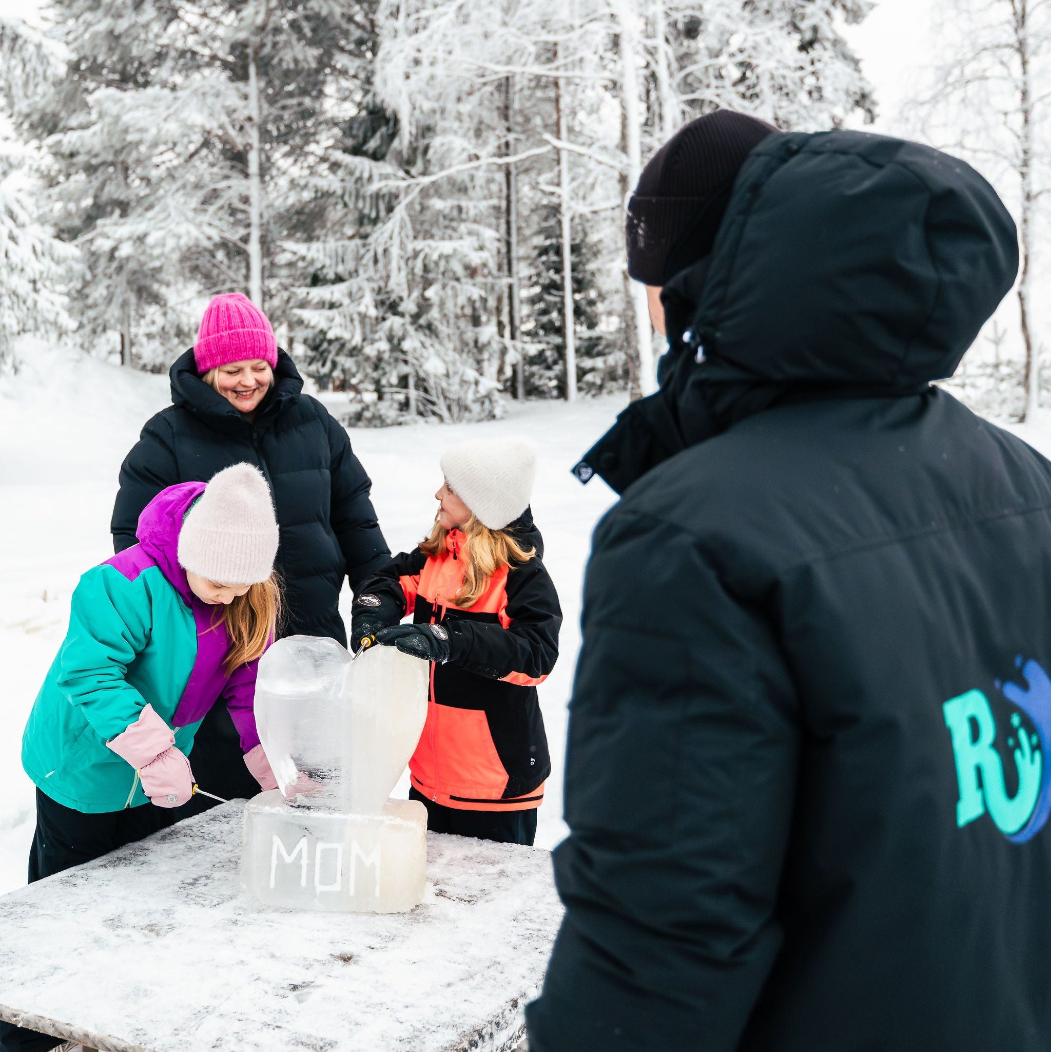 People making snow angels in a snowy forest