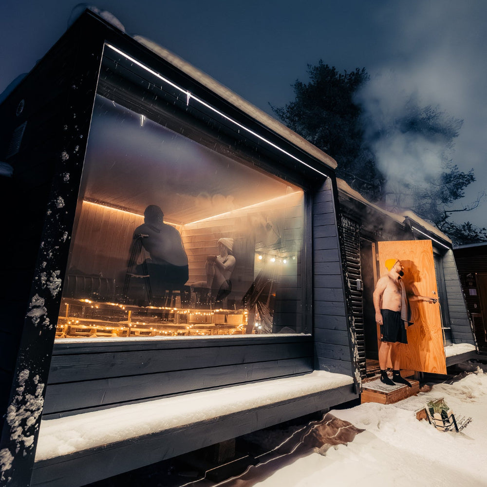 People enjoying saunas under the night sky and stars at Roiske Arctic Sauna Retreat