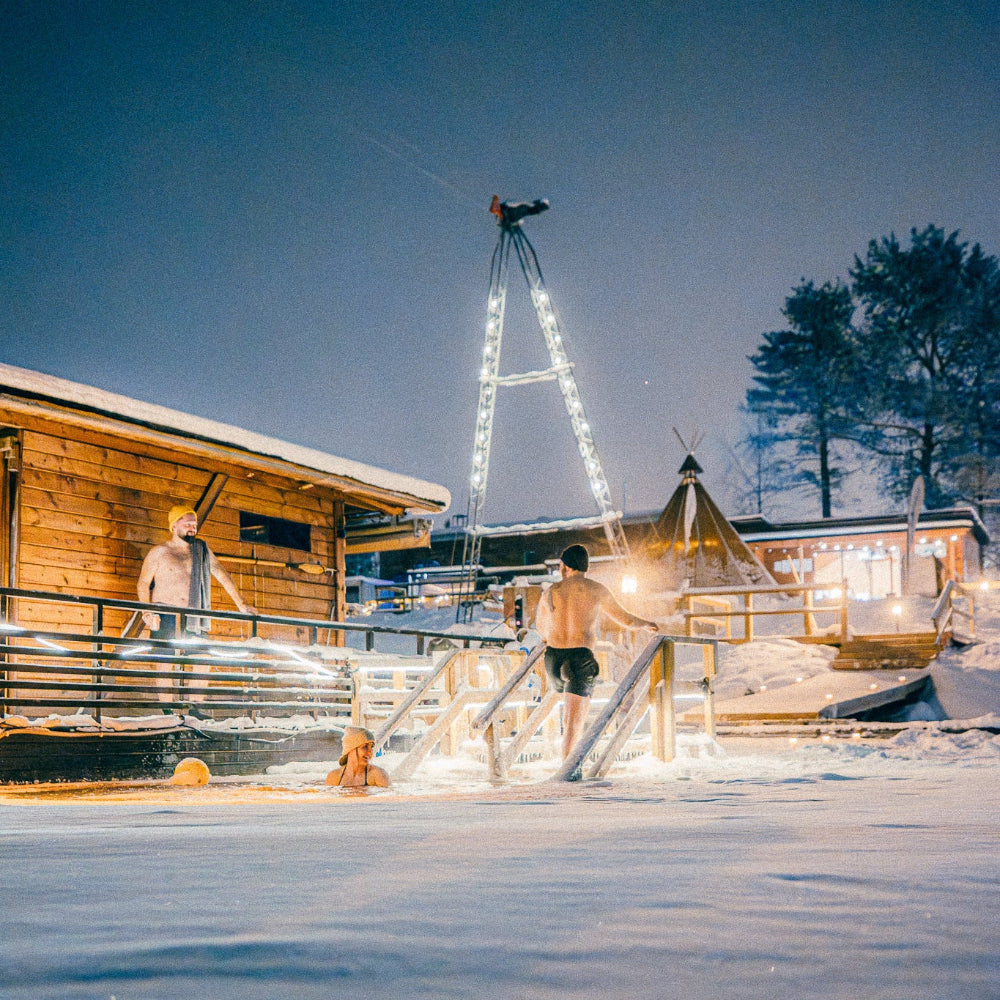 People enjoying ice swimming at Roiske Arctic Sauna Retreat