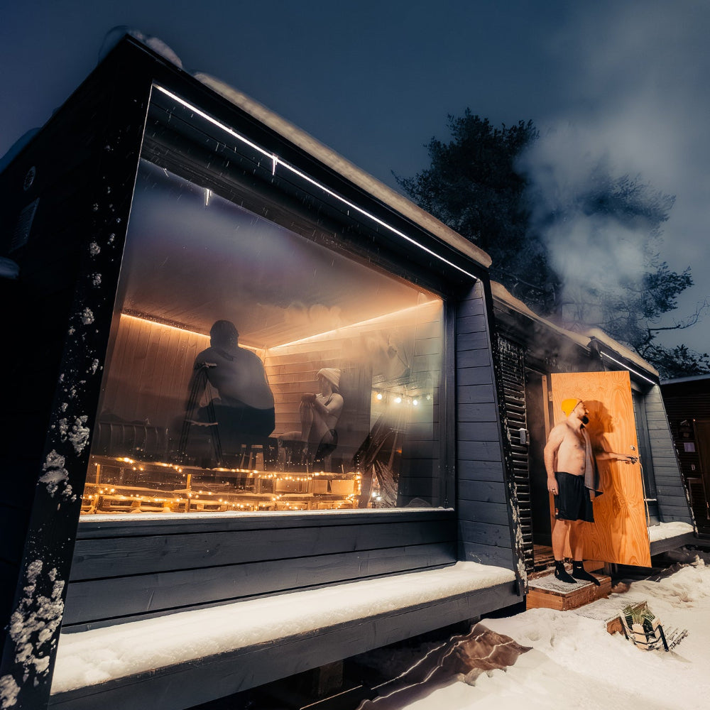 People enjoying saunas under the night sky and stars at Roiske Arctic Sauna Retreat